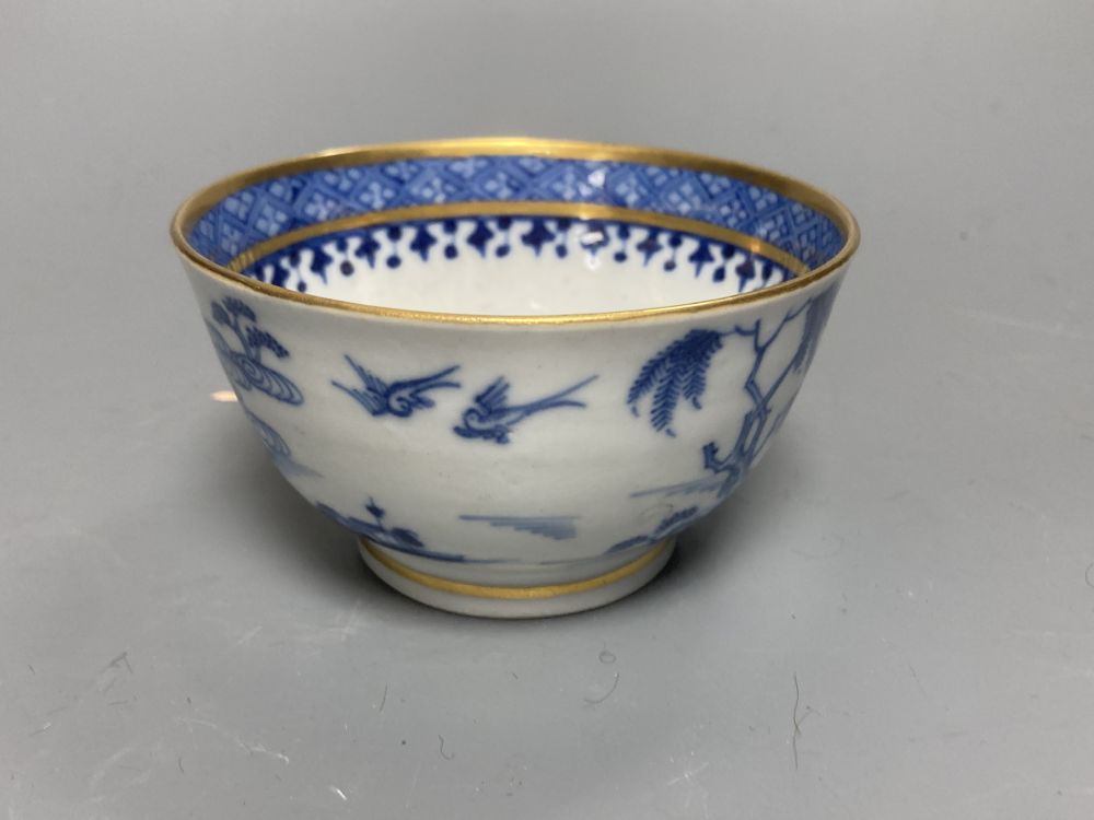 An 18th century English blue and white tea bowl and three smaller Chinese ceramic cups, two marks